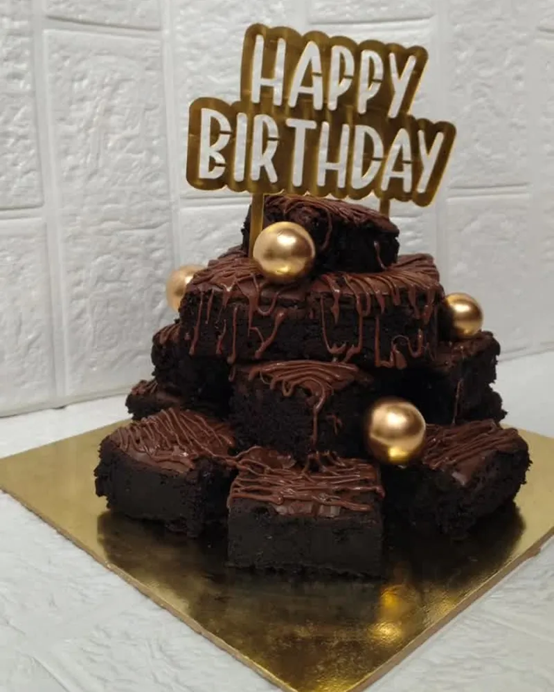 A brownie tower with a Happy Birthday topper