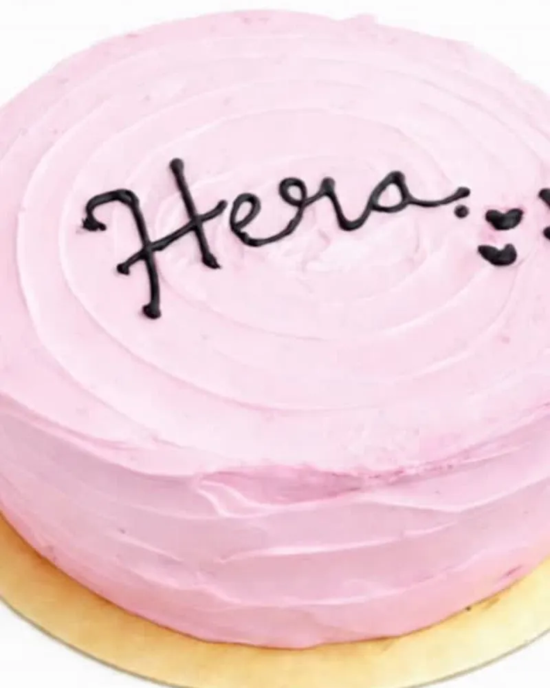 Lychee Rose Whisper cake with a name piped on top